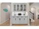 Stylish wet bar featuring white cabinetry, glass door uppers, and wine rack for a modern entertaining space at 3185 Viceroy Loop, Little River, SC 29566