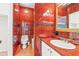 Bathroom featuring red tile, updated sink and toilet at 3597 Sunfish St., Murrells Inlet, SC 29576