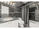 The stylish bathroom features dark tile, glass-accented trim, and modern fixtures at 3597 Sunfish St., Murrells Inlet, SC 29576