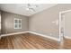 Neutral bedroom with hardwood floors, ceiling fan, and bright windows at 3597 Sunfish St., Murrells Inlet, SC 29576