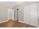 Bright bedroom features wood-look flooring, white doors, and neutral wall colors at 3597 Sunfish St., Murrells Inlet, SC 29576