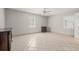 Bright bedroom featuring tile flooring, two windows for natural light, and closet space at 3597 Sunfish St., Murrells Inlet, SC 29576