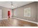 Light-filled bedroom featuring hardwood floors and an ensuite bathroom at 3597 Sunfish St., Murrells Inlet, SC 29576