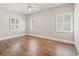 Sun-drenched bedroom featuring wood floors and multiple windows at 3597 Sunfish St., Murrells Inlet, SC 29576
