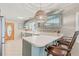 Charming kitchen with breakfast bar, decorative pendant lighting, and light-blue cabinets at 3597 Sunfish St., Murrells Inlet, SC 29576