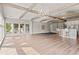 Open-concept living room with wood beams, hardwood floors, and a kitchen island with seating at 3597 Sunfish St., Murrells Inlet, SC 29576