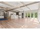 Bright living room showcasing wood beams, hardwood floors, and large windows allowing ample natural light at 3597 Sunfish St., Murrells Inlet, SC 29576