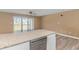 View of the kitchen featuring granite counter and stainless dishwasher. Sliding glass doors in the background at 3700 Golf Colony Lane # 25-D, Little River, SC 29566