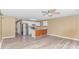 Open living space with view of the kitchen featuring white cabinetry, and stainless steel refrigerator and appliances at 3700 Golf Colony Lane # 25-D, Little River, SC 29566