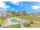 Community pool with lounge chairs and surrounding foliage at 3700 Golf Colony Lane # 25-D, Little River, SC 29566