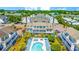 Aerial view of condo complex showcases pool, lush greenery, and ample parking at 3700 Golf Colony Lane # 2-J, Little River, SC 29566