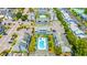 A captivating aerial view of a condo complex showcases its charming blue exterior and sparkling community pool at 3700 Golf Colony Lane # 2-J, Little River, SC 29566