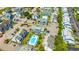 Aerial view featuring a pool, condo buildings, parking, and well-maintained landscaping at 3700 Golf Colony Lane # 2-J, Little River, SC 29566