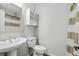 Bathroom with pedestal sink, white toilet, storage cabinet and neutral shower curtain at 3700 Golf Colony Lane # 2-J, Little River, SC 29566