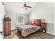 Light-green bedroom boasts vaulted ceiling, window, and dark wood furnishings at 3700 Golf Colony Lane # 2-J, Little River, SC 29566