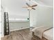 Bedroom features a ceiling fan, wood-look floors, and loft area with shelves at 3700 Golf Colony Lane # 2-J, Little River, SC 29566