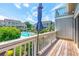Balcony overlooks a community pool surrounded by well-maintained buildings and greenery at 3700 Golf Colony Lane # 2-J, Little River, SC 29566