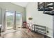 Living room features a sliding glass door to a balcony, red bistro table, and spiral stairs at 3700 Golf Colony Lane # 2-J, Little River, SC 29566