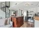 Open-concept living area featuring a spiral staircase, a kitchen with an island, and a cozy sofa at 3700 Golf Colony Lane # 2-J, Little River, SC 29566