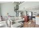 Inviting living room with a spiral staircase, comfortable sofa, and a kitchen view at 3700 Golf Colony Lane # 2-J, Little River, SC 29566