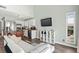 Living room featuring access to the kitchen with sleek appliances and a TV at 3700 Golf Colony Lane # 2-J, Little River, SC 29566