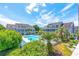 Community pool area surrounded by well-kept condos, tropical plants, and landscaping at 3700 Golf Colony Lane # 2-J, Little River, SC 29566