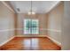 Bright dining room featuring hardwood floors, a stylish chandelier, and a large window at 391 William Nobles Rd., Aynor, SC 29511