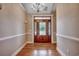 Elegant foyer features a leaded glass door, chandelier, hardwood floors, and neutral wall colors at 391 William Nobles Rd., Aynor, SC 29511