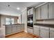 Open kitchen with grey cabinets, stainless steel appliances, and adjacent dining area at 391 William Nobles Rd., Aynor, SC 29511