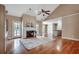 Spacious living room with hardwood flooring, fireplace, and large windows offering ample natural light at 391 William Nobles Rd., Aynor, SC 29511