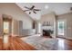 Bright living room boasts a fireplace, hardwood floors, a ceiling fan, and access to the bathroom at 391 William Nobles Rd., Aynor, SC 29511