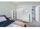 Comfortable bedroom with neutral colors, closet, dresser, and doorway to the laundry room at 3951 Gladiola Ct. # 104, Myrtle Beach, SC 29588