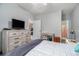Comfortable bedroom with light gray walls, desk, tv, and view to the bathroom at 3951 Gladiola Ct. # 104, Myrtle Beach, SC 29588