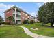 Low angle shot of the condo complex with balconies and green space on a partly cloudy day at 3951 Gladiola Ct. # 104, Myrtle Beach, SC 29588