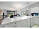 Open kitchen with white countertops and view into the living area at 3951 Gladiola Ct. # 104, Myrtle Beach, SC 29588