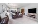 Cozy living room with carpet, sofas, tv, and kitchen view at 3951 Gladiola Ct. # 104, Myrtle Beach, SC 29588