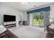 Light-filled living room featuring a large window, comfortable seating, and modern media center at 3951 Gladiola Ct. # 104, Myrtle Beach, SC 29588