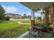 Covered patio with seating and views of landscaped grounds and community pool at 3951 Gladiola Ct. # 104, Myrtle Beach, SC 29588