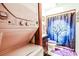 A compact bathroom, showcasing stacked washer-dryer and shower with dark-blue tree-themed shower curtain at 404 72Nd Ave. N # 301, Myrtle Beach, SC 29572