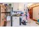 A view of the kitchen, with a stainless steel refrigerator with magnets and photos, plus white cabinets and a trash can at 404 72Nd Ave. N # 301, Myrtle Beach, SC 29572