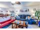 An open-concept living space features a large blue sofa, a red couch, and a dining area, great for entertaining and relaxation at 404 72Nd Ave. N # 301, Myrtle Beach, SC 29572