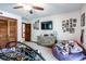 A cozy bedroom includes a large wardrobe, ceiling fan, lots of photos, and a TV at 404 72Nd Ave. N # 301, Myrtle Beach, SC 29572