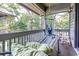 Relaxing screened-in porch with a hammock, comfortable seating, and view of the woods at 404 72Nd Ave. N # 301, Myrtle Beach, SC 29572