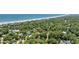 Aerial view showcasing proximity to the beach, mature trees, and neighborhood at 412 Middleton Dr., Pawleys Island, SC 29585