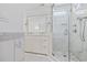 Well lit bathroom with marble tile, glass shower, and a double vanity at 412 Middleton Dr., Pawleys Island, SC 29585