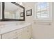 Clean bathroom featuring a white vanity, large mirror, and natural light at 412 Middleton Dr., Pawleys Island, SC 29585