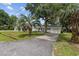 View of the home's driveway and manicured front lawn showcasing its beautiful landscaping at 412 Middleton Dr., Pawleys Island, SC 29585