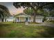 Charming single-story home featuring a well-manicured lawn and an inviting front porch with blue shutters at 412 Middleton Dr., Pawleys Island, SC 29585