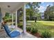 Covered front porch with patio seating and well-manicured landscaping at 412 Middleton Dr., Pawleys Island, SC 29585