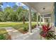 Covered porch with a variety of colorful plants and comfortable seating at 412 Middleton Dr., Pawleys Island, SC 29585